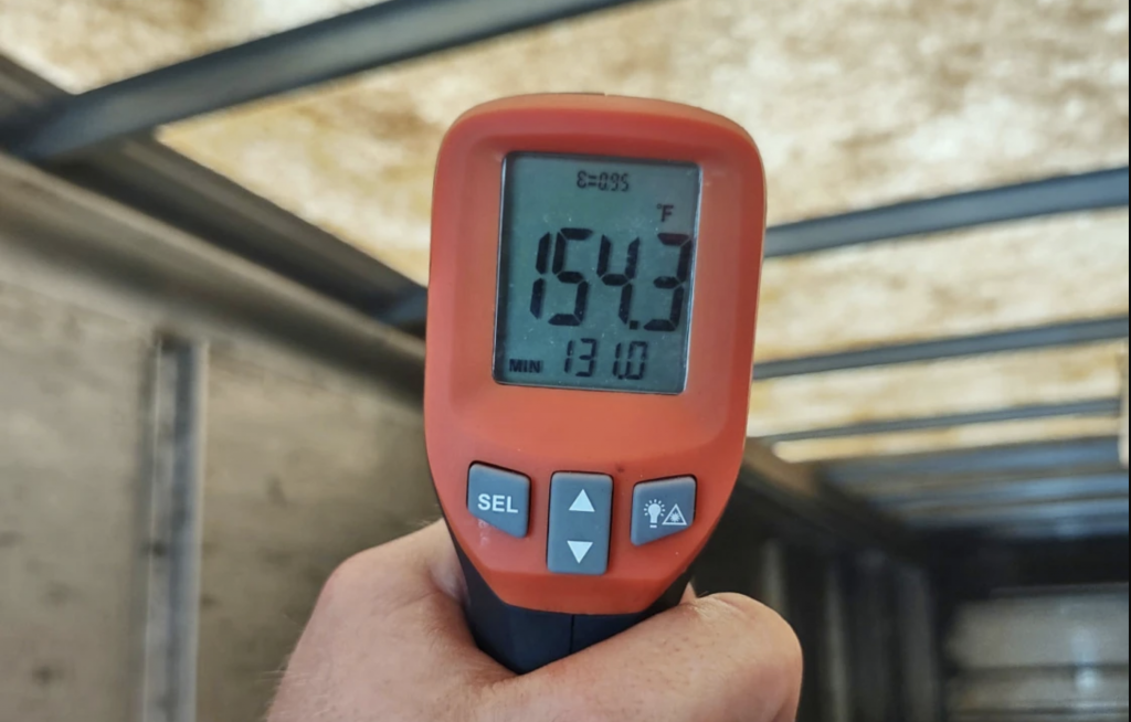 Temperature gun shows 154.3 Fahrenheit in the back of a UPS delivery truck.