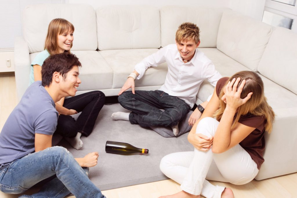 Friends playing Spin The Bottle party game